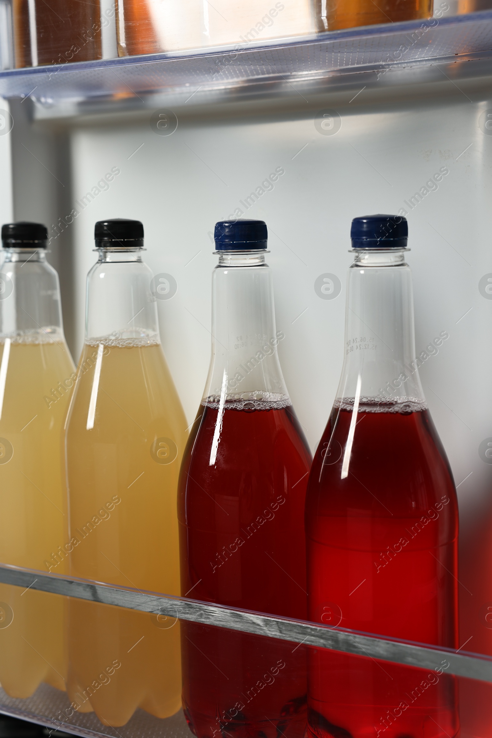 Photo of Many different cold drinks in refrigerator, closeup