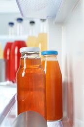 Many different cold drinks in refrigerator, closeup