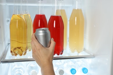 Photo of Woman taking bottle with drink from refrigerator, closeup