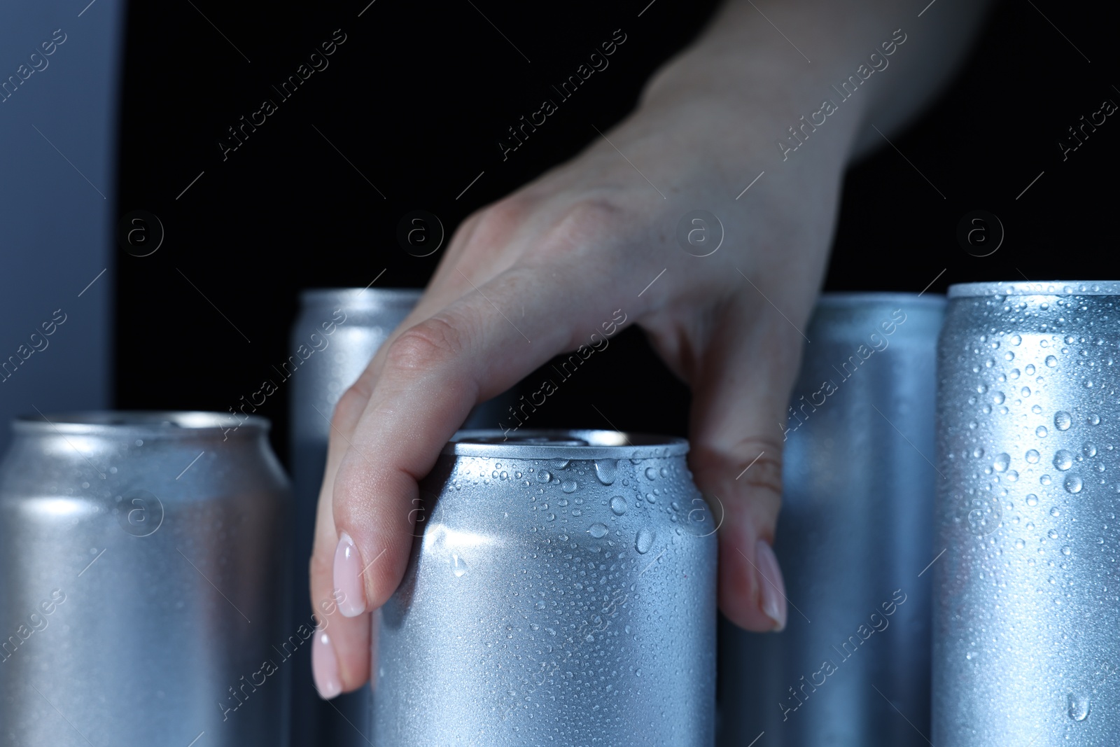 Photo of Woman taking can of beer from refrigerator, closeup