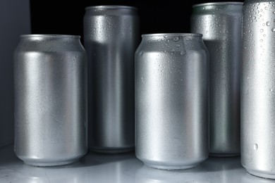 Photo of Many cans of beer in refrigerator, closeup