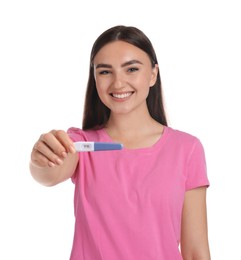 Happy woman holding pregnancy test on white background