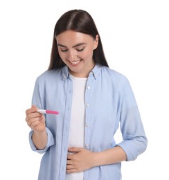 Photo of Happy woman holding pregnancy test on white background