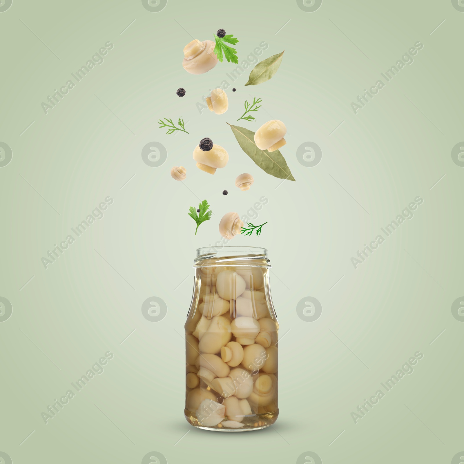 Image of Jar with pickled champignons and ingredients falling into it on color background