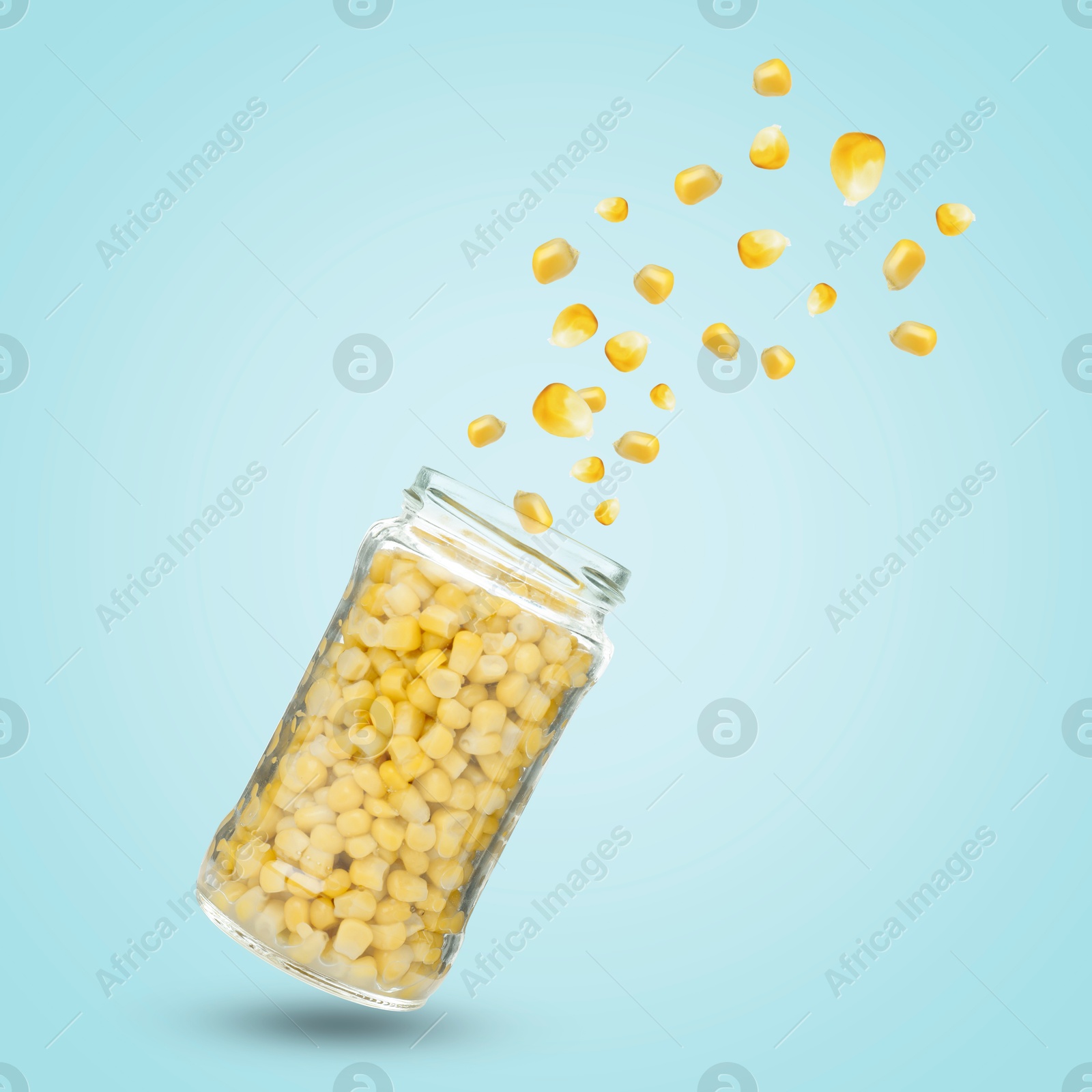 Image of Jar with corns in air on light blue background