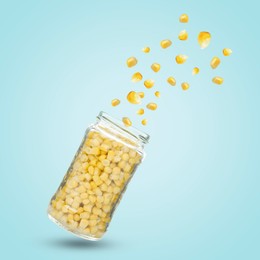 Image of Jar with corns in air on light blue background