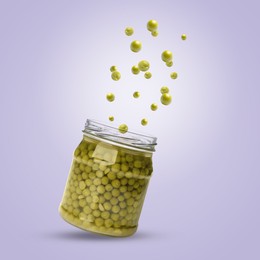 Image of Jar with pickled green peas in air on violet background