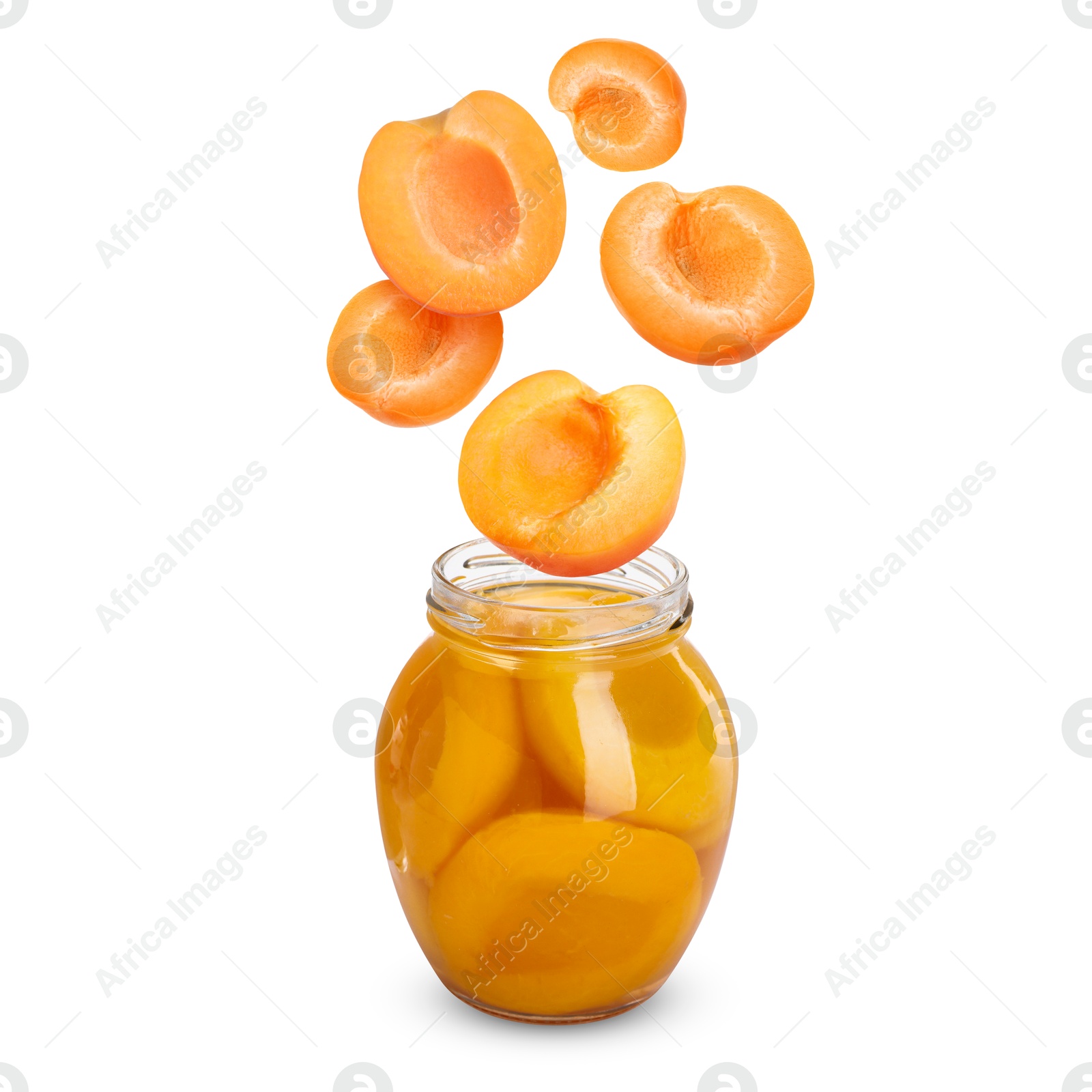 Image of Apricots falling into jar on white background