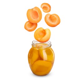 Image of Apricots falling into jar on white background