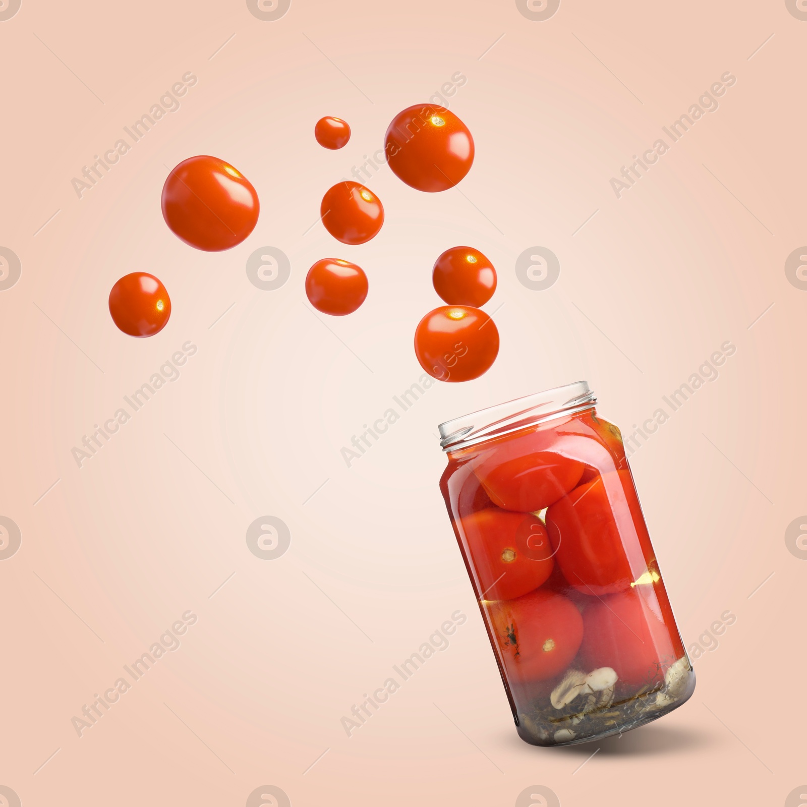 Image of Jar with tomatoes in air on pale red background