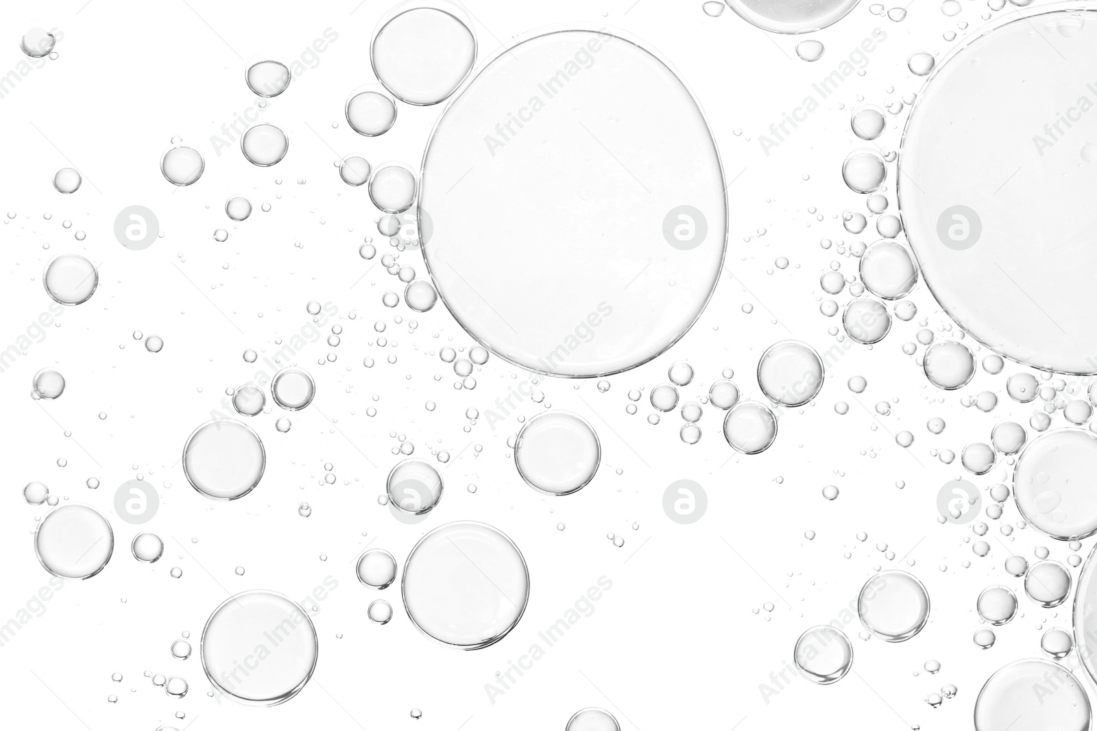 Image of Clear cosmetic oil on white background, top view