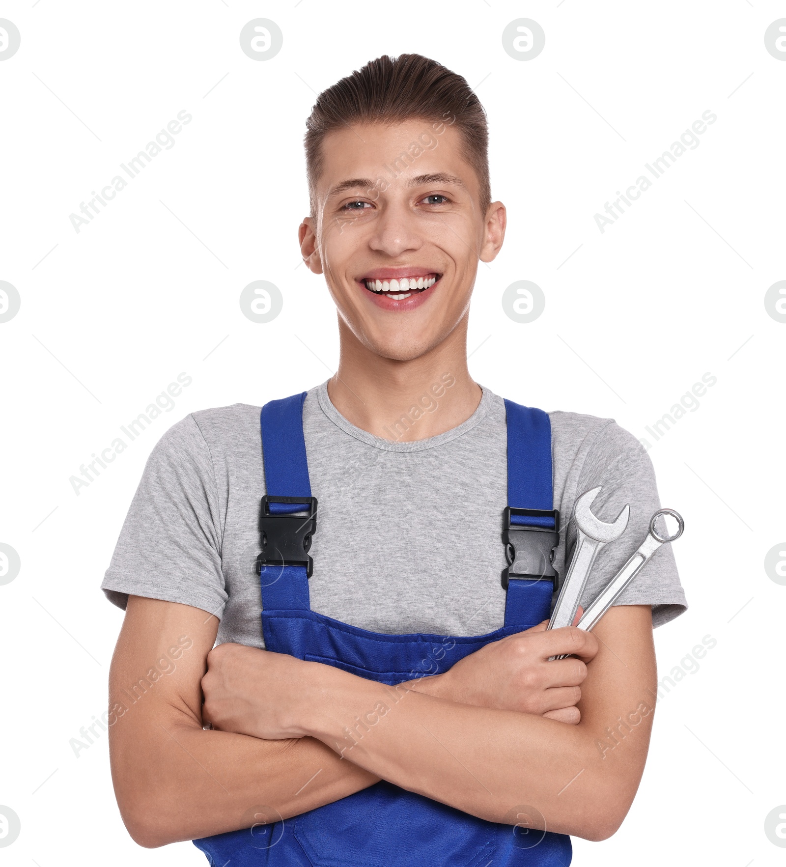 Photo of Smiling auto mechanic with wrenches on white background