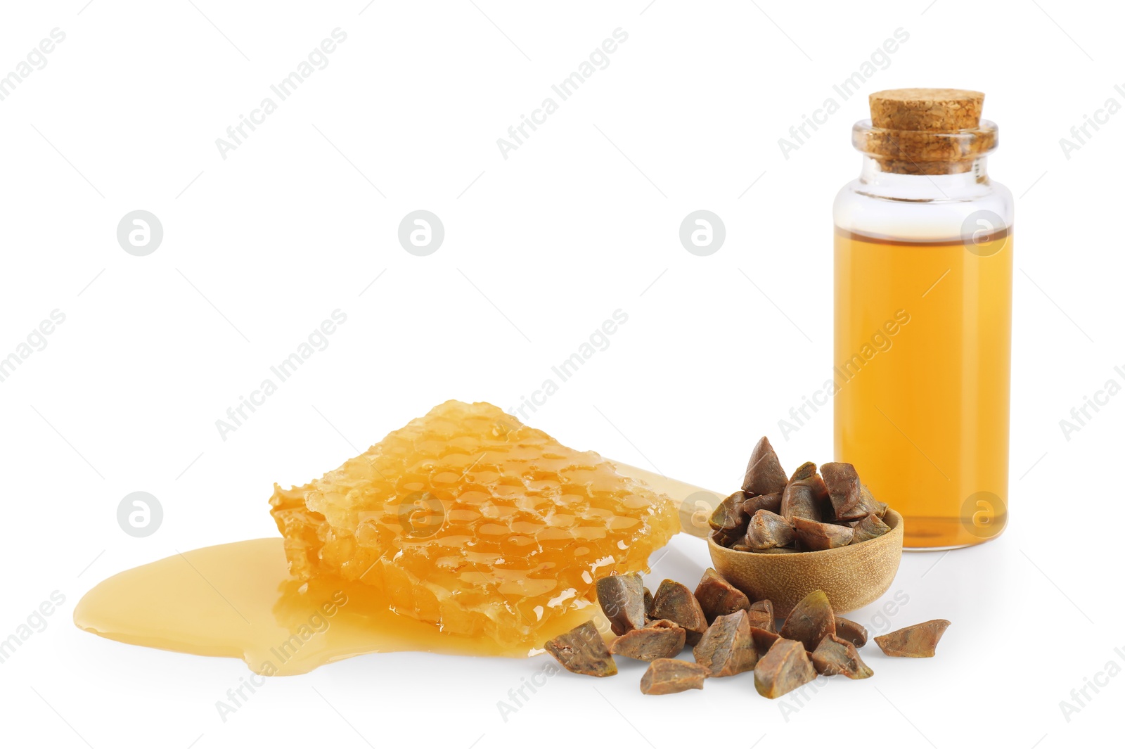 Photo of Natural honey tincture, propolis granules and sweet honeycomb isolated on white