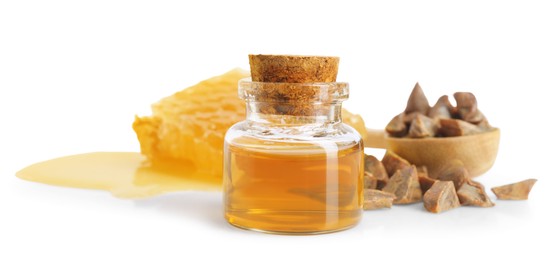 Photo of Natural honey tincture, propolis granules and sweet honeycomb isolated on white