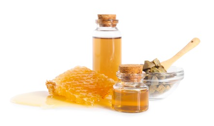 Photo of Natural honey tincture, propolis granules and sweet honeycomb isolated on white