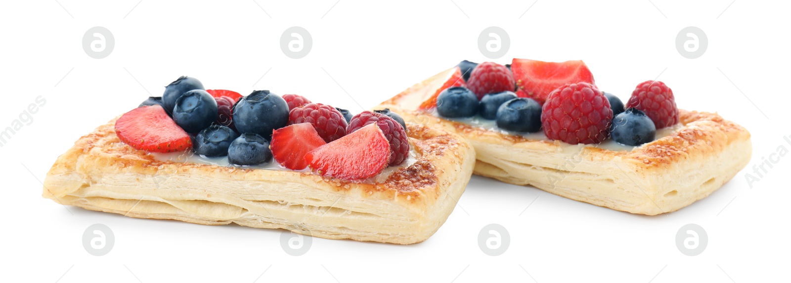 Photo of Tasty puff pastries with berries isolated on white