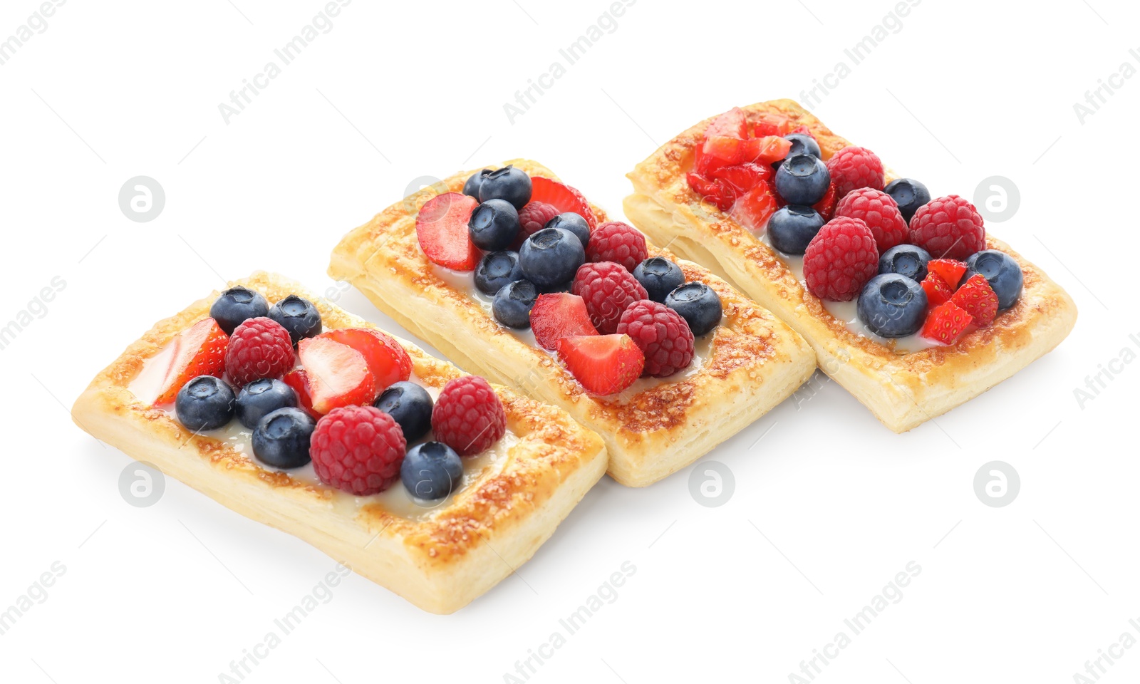 Photo of Tasty puff pastries with berries isolated on white