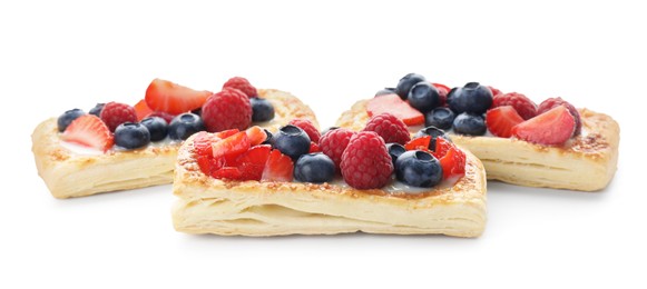 Photo of Tasty puff pastries with berries isolated on white