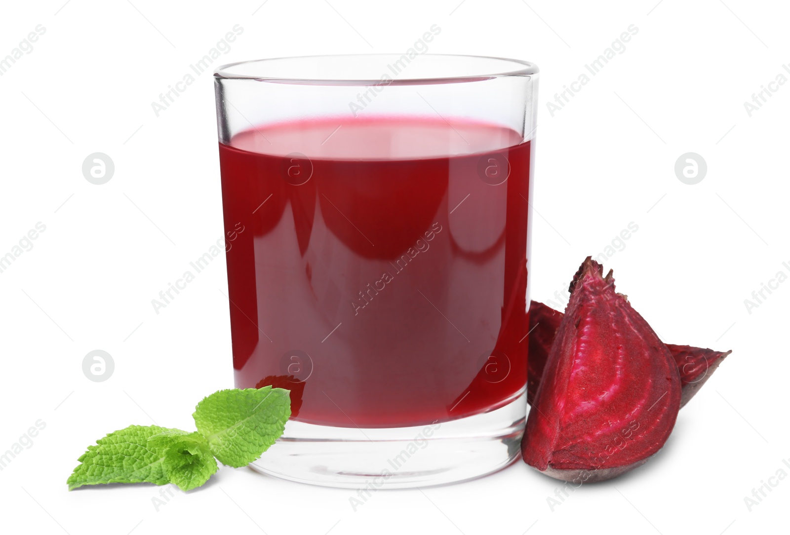 Photo of Fresh beet juice in glass, pieces of vegetable and mint isolated on white