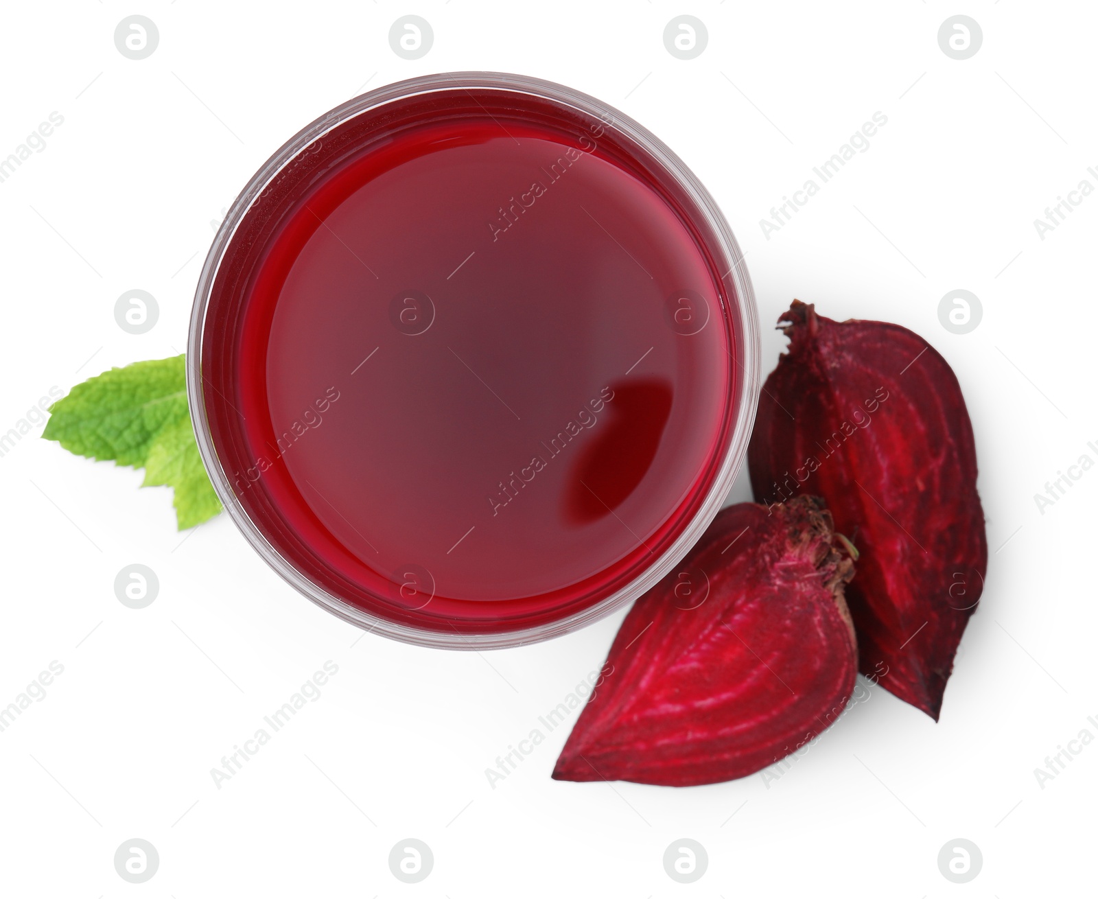 Photo of Fresh beet juice in glass, pieces of vegetable and mint isolated on white, top view