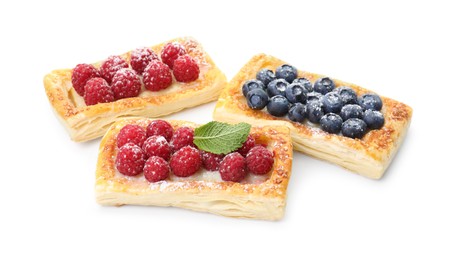 Photo of Tasty puff pastries with berries isolated on white