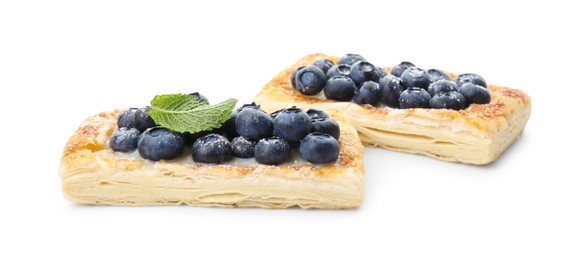 Photo of Tasty puff pastries with blueberries isolated on white