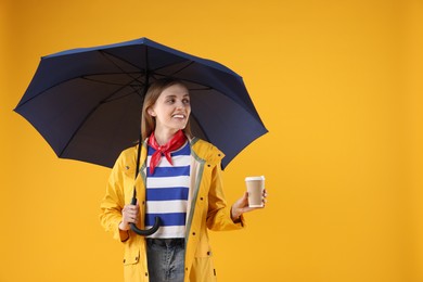 Photo of Woman with blue umbrella and paper cup on yellow background, space for text