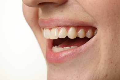 Smiling woman with healthy clean teeth on white background, closeup