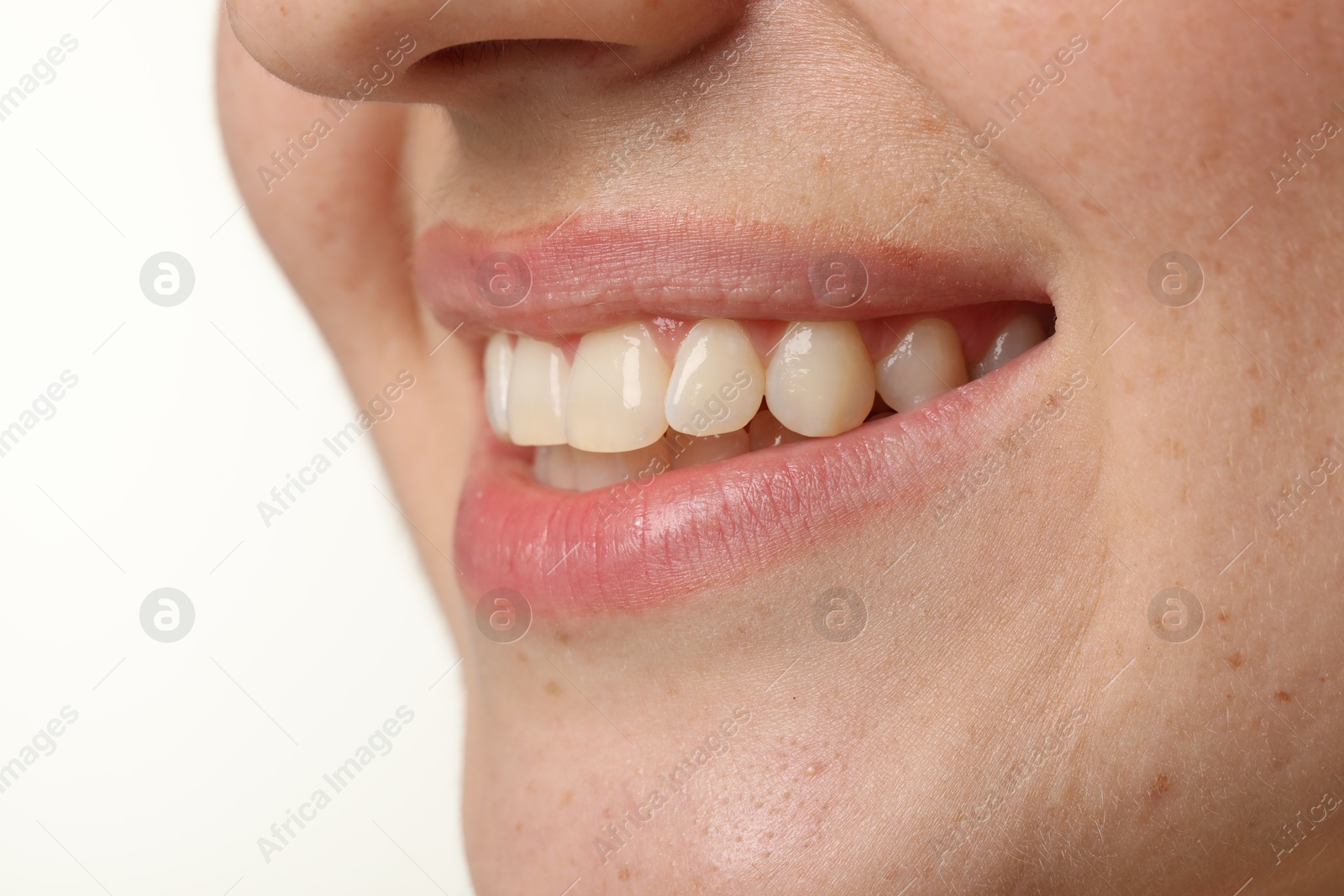 Photo of Smiling woman with healthy clean teeth on white background, closeup