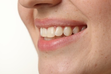 Smiling woman with healthy clean teeth on white background, closeup