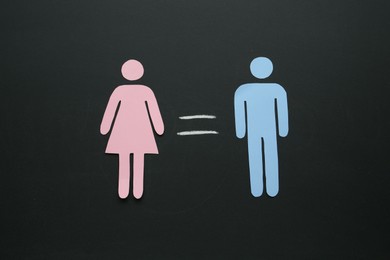 Gender equality concept. Male and female figures on chalkboard, flat lay