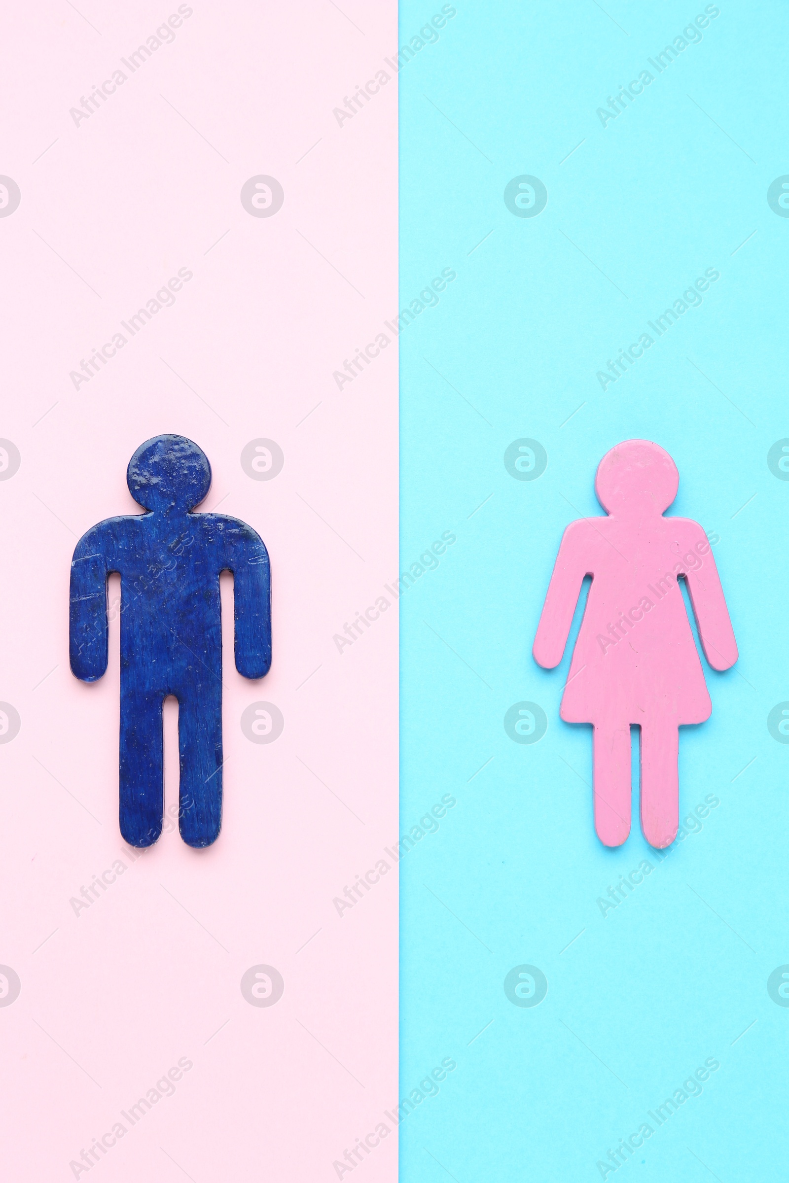 Photo of Gender equality concept. Male and female figures on color background, flat lay