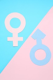 Photo of Gender equality concept. Male and female symbols on color background, flat lay