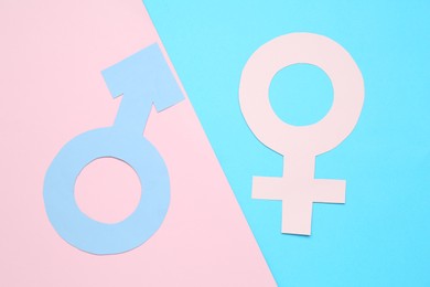 Gender equality concept. Male and female symbols on color background, flat lay