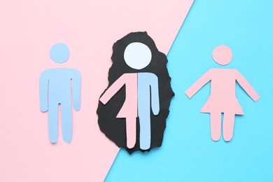 Photo of Gender equality concept. Male and female figures on color background, flat lay