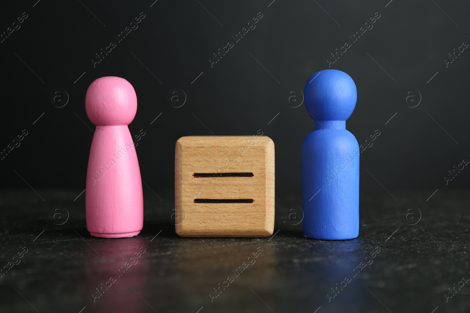 Photo of Gender equality concept. Male and female figures on grey textured table