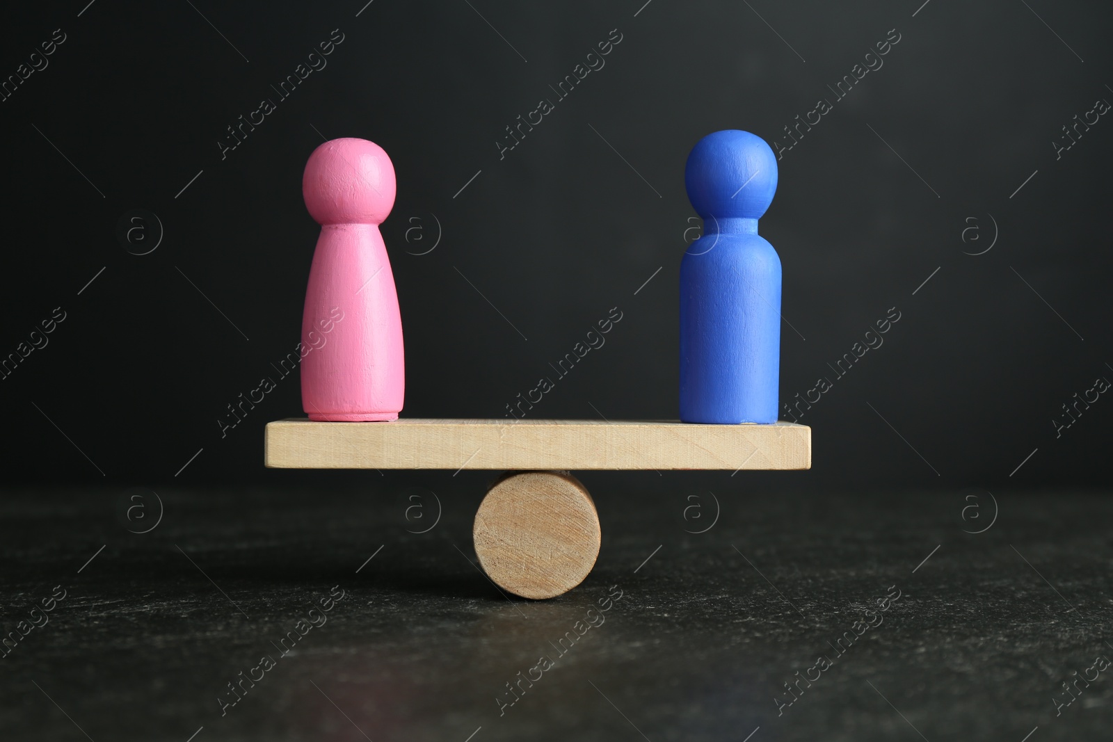 Photo of Gender equality concept. Male and female figures on scales against grey background