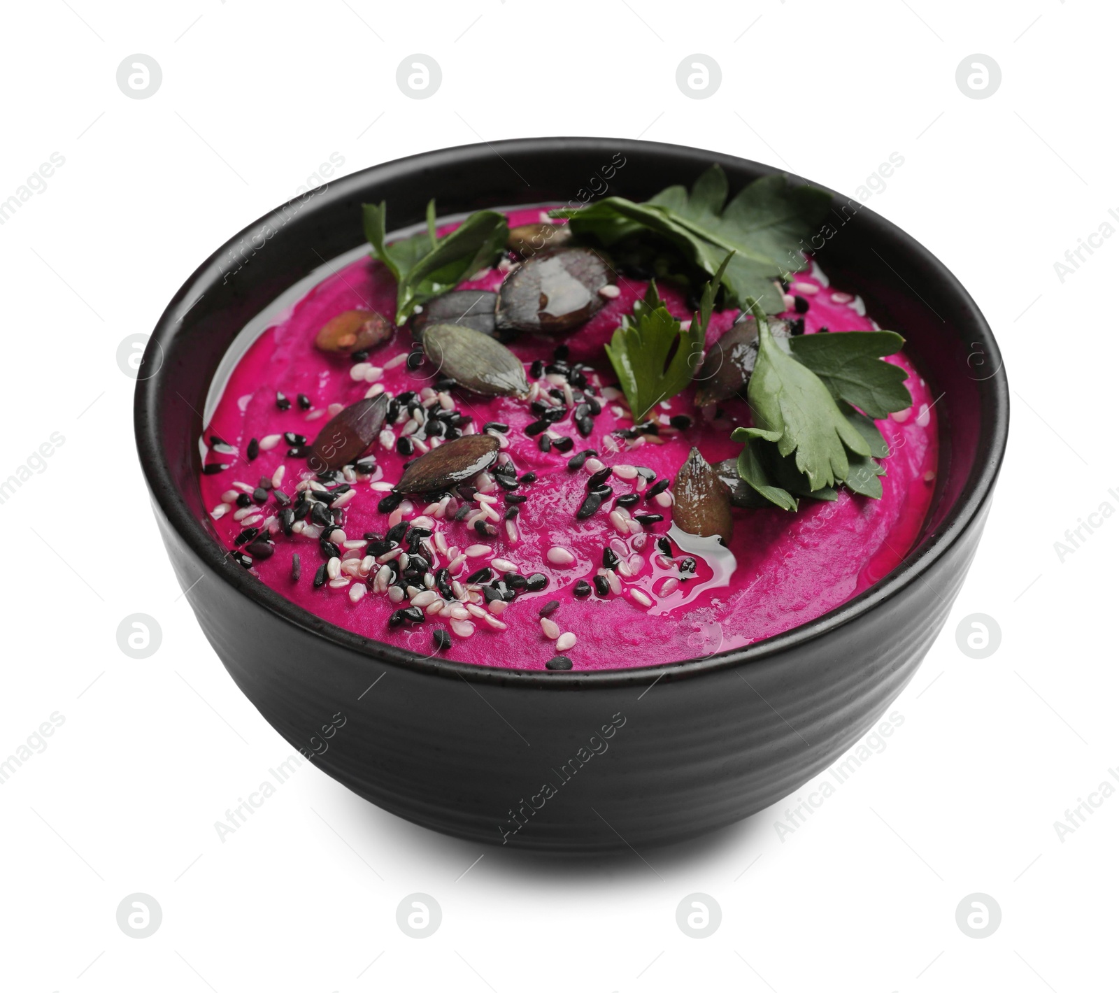 Photo of Tasty beetroot hummus, parsley and sesame in bowl isolated on white