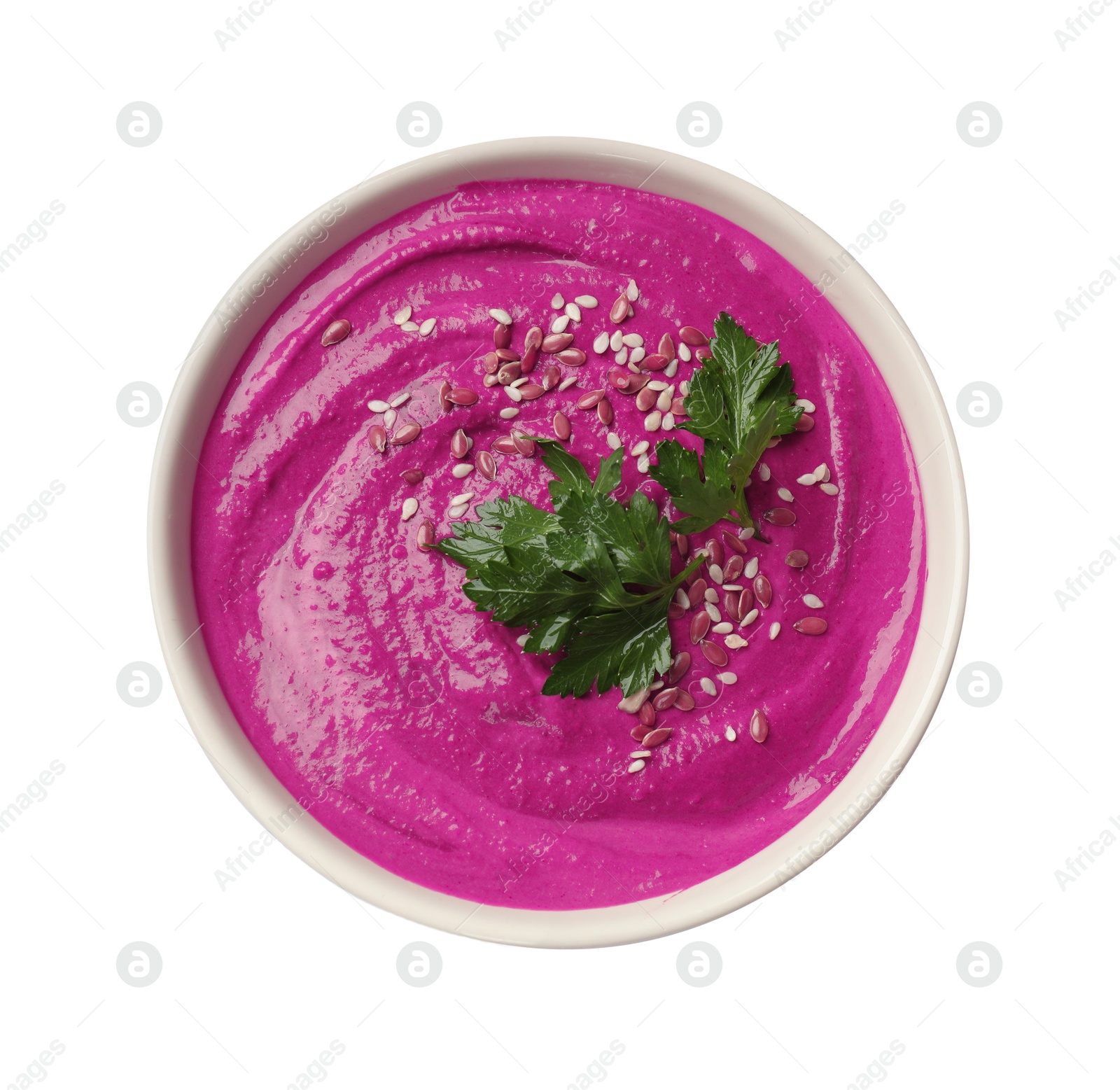 Photo of Tasty beetroot hummus, parsley and sesame in bowl isolated on white, top view