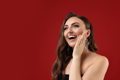 Photo of Portrait of happy woman on red background. Space for text