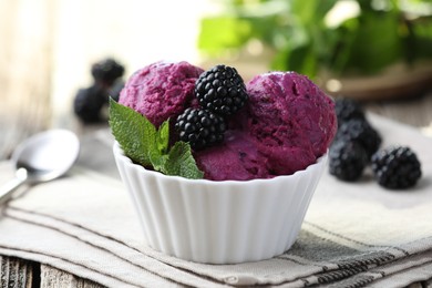 Photo of Delicious blackberry sorbet, mint and fresh berries on wooden table, closeup