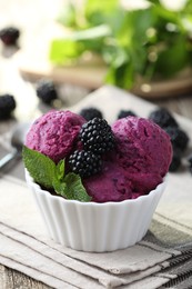 Photo of Delicious blackberry sorbet, mint and fresh berries on wooden table, closeup