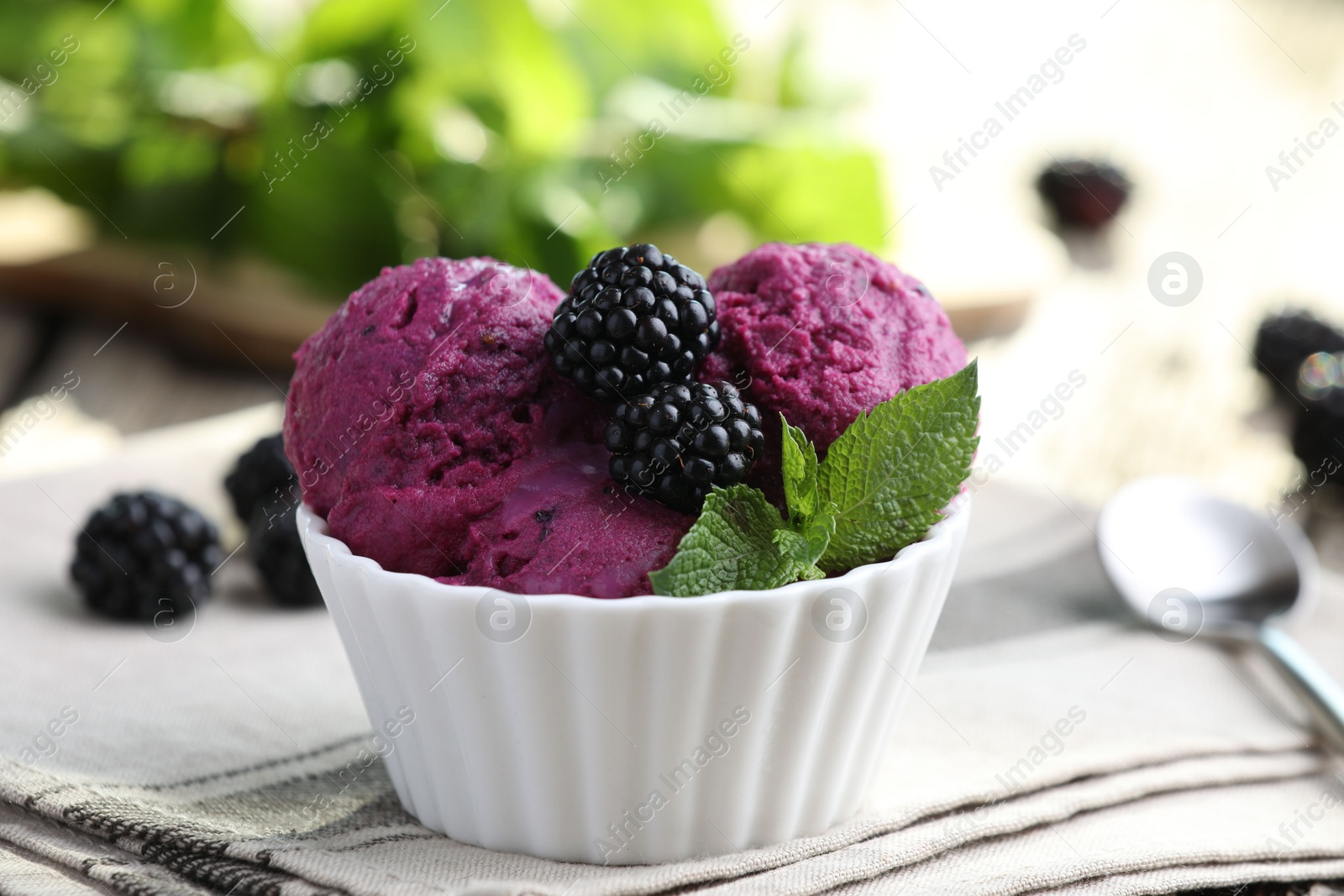 Photo of Delicious blackberry sorbet, mint and fresh berries on wooden table, closeup