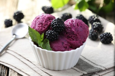 Delicious blackberry sorbet, mint and fresh berries on wooden table, closeup