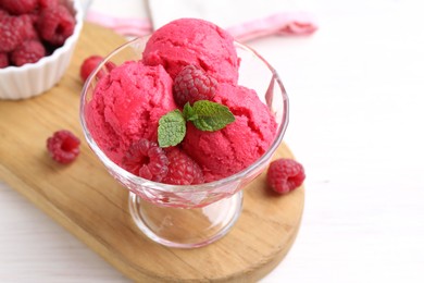 Photo of Delicious raspberry sorbet, mint and fresh berries on white wooden table, closeup. Space for text