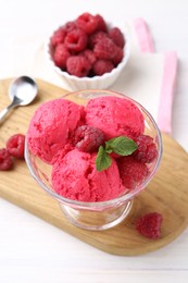 Photo of Delicious raspberry sorbet, mint and fresh berries on white wooden table, closeup