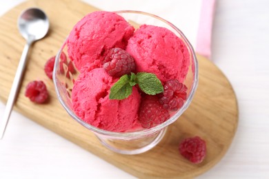 Delicious raspberry sorbet, mint and fresh berries on white wooden table, closeup