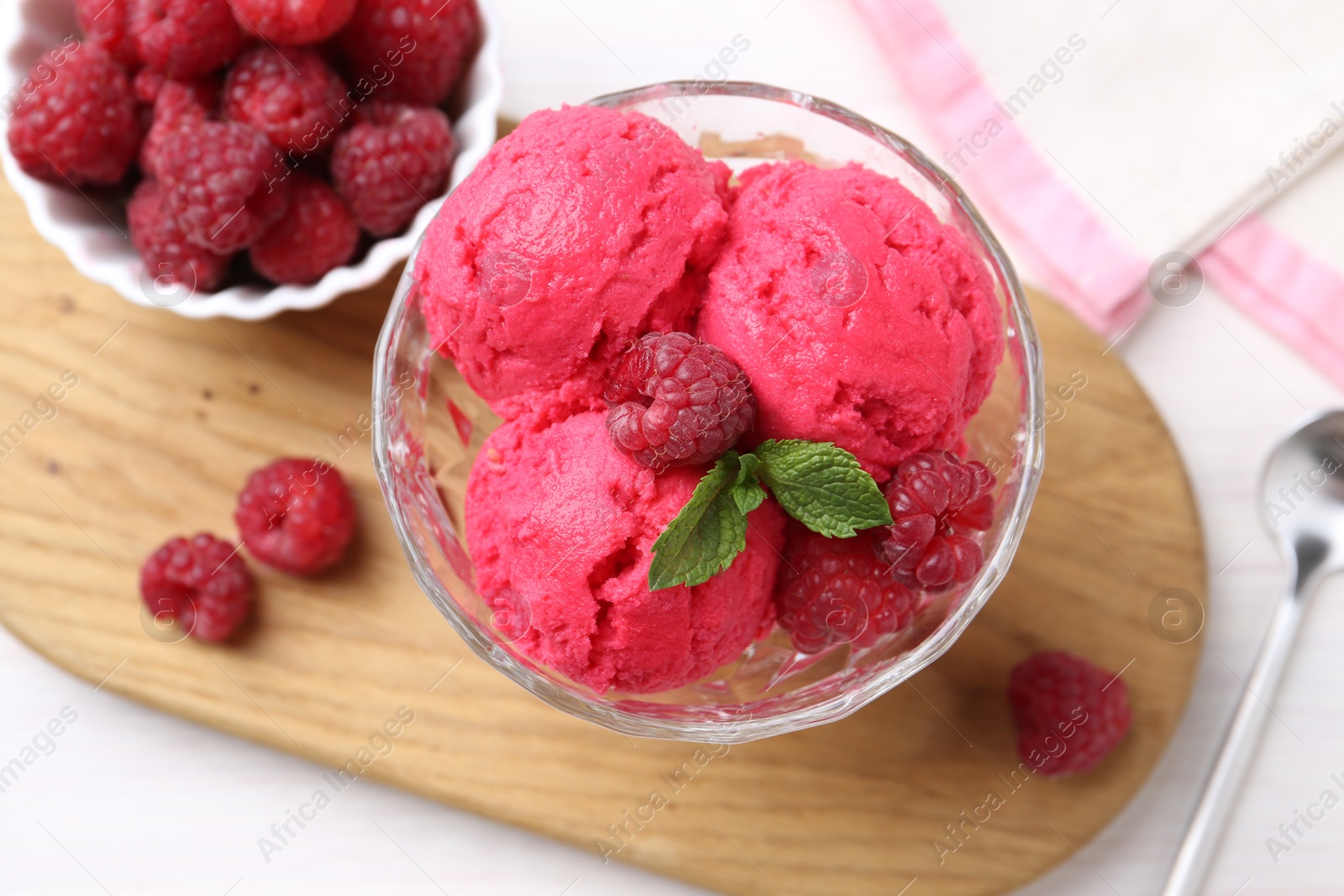 Photo of Delicious raspberry sorbet, mint and fresh berries on white wooden table, top view