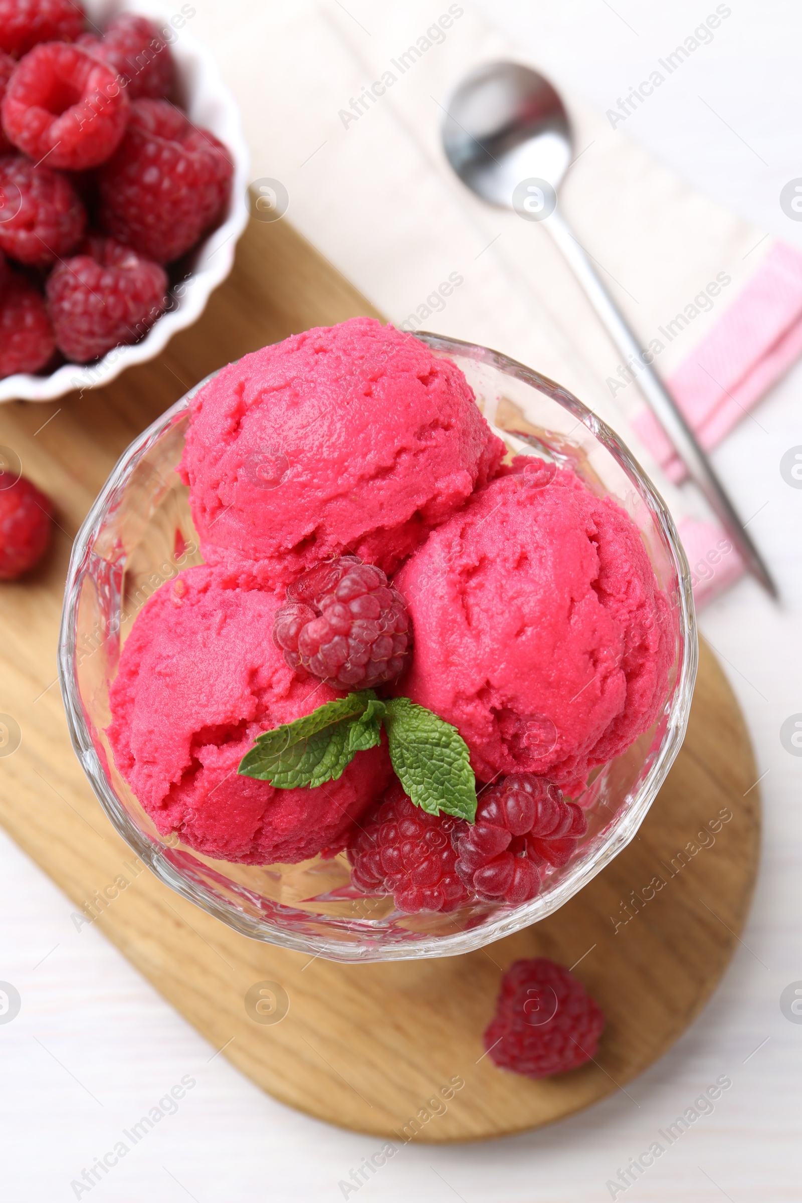 Photo of Delicious raspberry sorbet, mint and fresh berries on white wooden table, top view