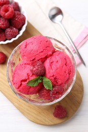 Delicious raspberry sorbet, mint and fresh berries on white wooden table, top view